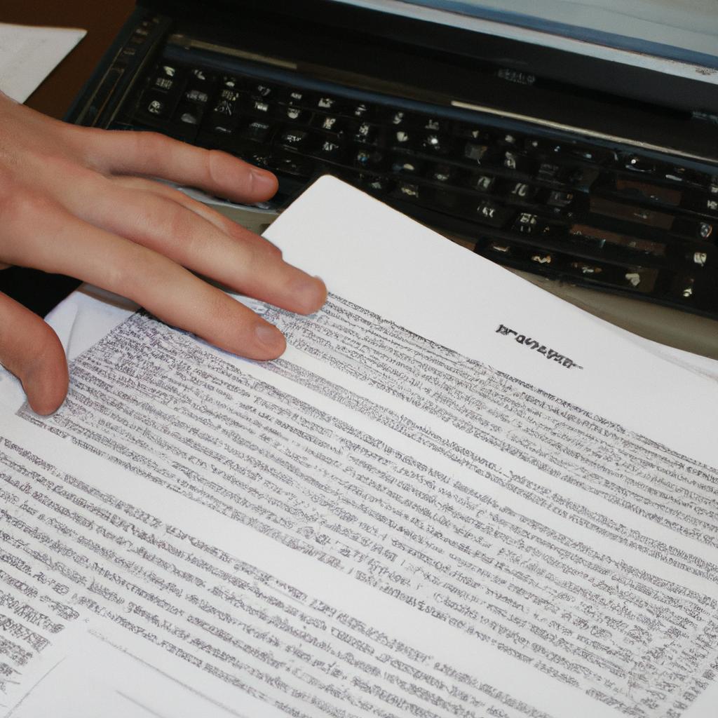 Person reading legal documents, typing